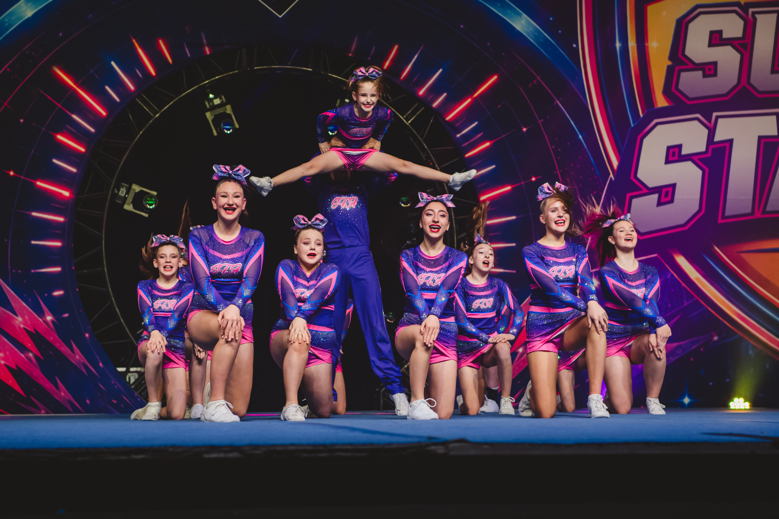 STA athletes competing together on the cheerleading competition floor