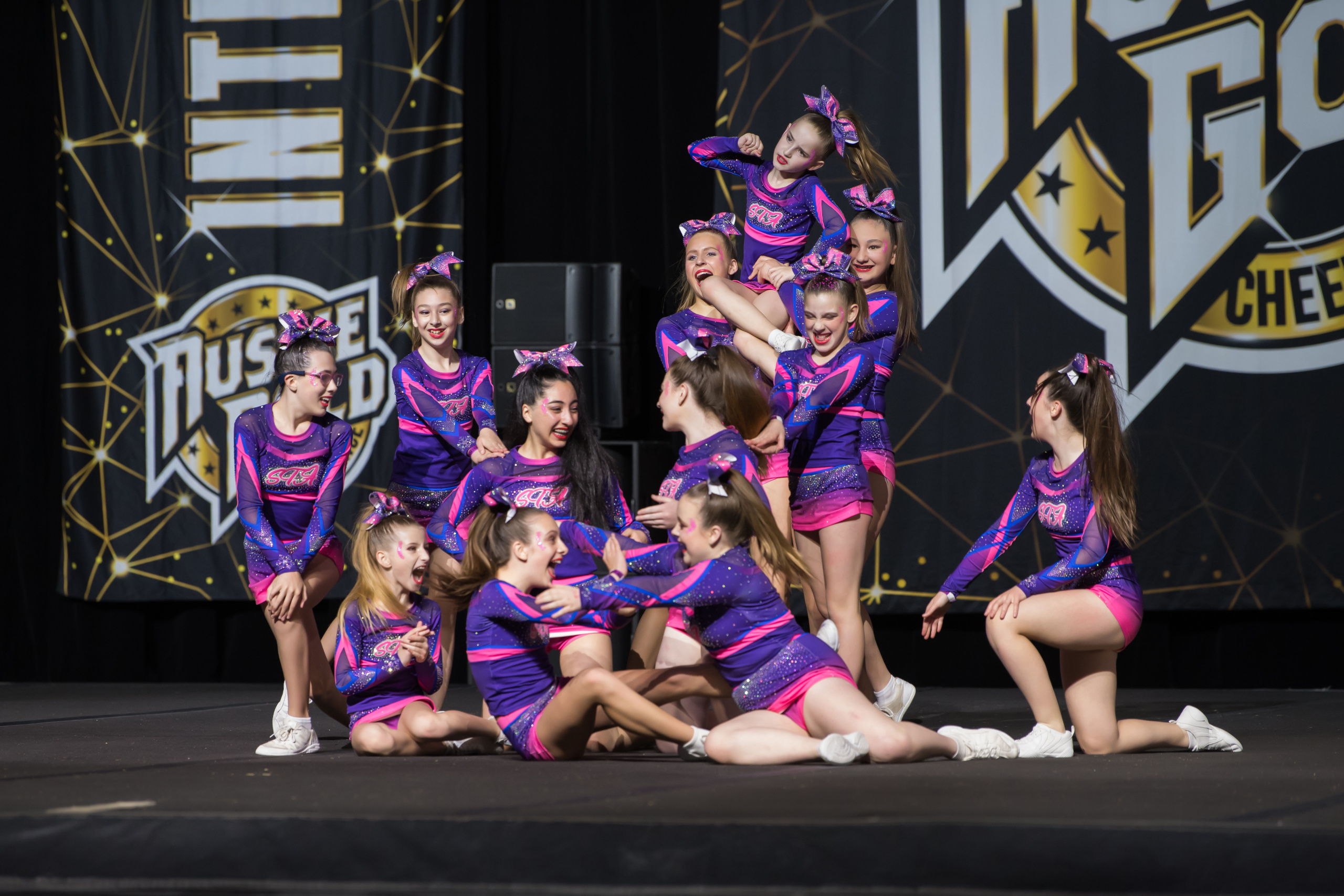 Sunbury Stunt and Tumble Academy athletes celebrating together at a cheerleading competition